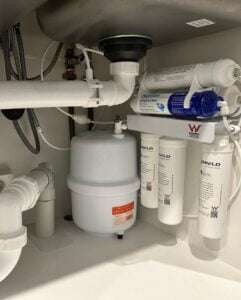 Under-sink water filtration system installed by Bay Plumbing and Drainage in Geelong, featuring multiple filtration units.