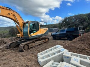 Excavator and truck on construction site