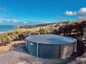 Coastal water tank installation by Bay Plumbing and Drainage in Geelong, overlooking scenic ocean views.