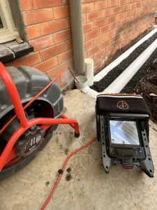 Newly replaced drainage pipe next to home after emergency plumbing works.