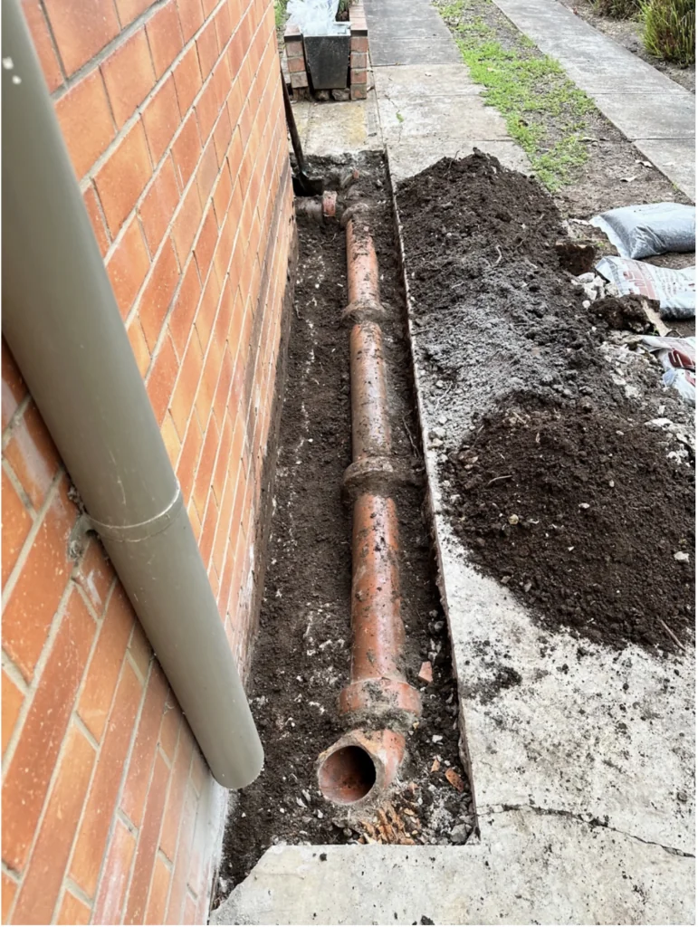 Exposed drainage pipe undergoing repair by Bay Plumbing and Drainage in Geelong, showcasing expert plumbing services.