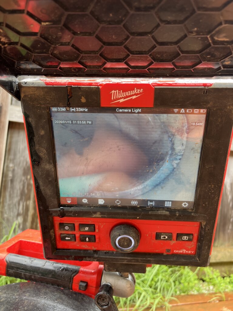 CCTV drain inspection camera monitor showing internal sewer pipe condition and structural failures
