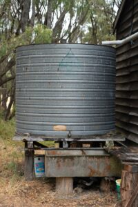 Image of a rainwater tank outside of a house.