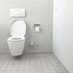 Minimalist white bathroom with toilet.