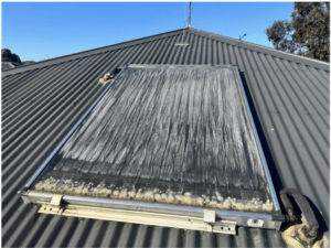 Rooftop solar water heater system installed by Bay Plumbing and Drainage in Geelong, showing signs of wear and maintenance needs.